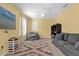 Bright game room features a comfy couch, beanbag chair, and shelving for games and toys at 20811 Sullivan Ranch Blvd, Mount Dora, FL 32757