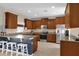 Kitchen with wooden cabinetry, granite countertops, and stainless steel appliances at 20811 Sullivan Ranch Blvd, Mount Dora, FL 32757