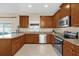 Kitchen with wooden cabinetry, granite countertops, and stainless steel appliances at 20811 Sullivan Ranch Blvd, Mount Dora, FL 32757