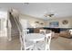 Living room with white table, four chairs, and staircase view at 20811 Sullivan Ranch Blvd, Mount Dora, FL 32757