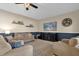 Cozy living room featuring neutral tones and a large TV at 20811 Sullivan Ranch Blvd, Mount Dora, FL 32757