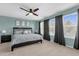Main bedroom with a large bed, nightstands, and plenty of natural light at 20811 Sullivan Ranch Blvd, Mount Dora, FL 32757