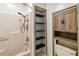Functional bathroom with built-in shelving, a shower stall, and vanity storage at 211 Indiana Ave, St Cloud, FL 34769