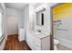 A renovated bathroom with modern vanity, white fixtures, and an enclosed closet at 211 Indiana Ave, St Cloud, FL 34769