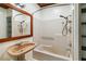 A quaint bathroom with a unique sink, neutral-colored tile, and a mirror with a wood frame at 211 Indiana Ave, St Cloud, FL 34769