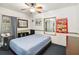 Cozy bedroom with a bed, ceiling fan, neutral colors, and a window for natural light at 211 Indiana Ave, St Cloud, FL 34769
