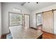 Open-concept with a barn door, and view to front door and dining area at 211 Indiana Ave, St Cloud, FL 34769