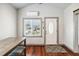 Inviting entryway with a decorative door, window, and hardwood floors at 211 Indiana Ave, St Cloud, FL 34769