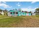 Inviting blue one story house boasting a spacious yard and covered porch at 211 Indiana Ave, St Cloud, FL 34769