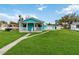 A charming blue single-story home with a cozy porch and lush green lawn at 211 Indiana Ave, St Cloud, FL 34769