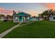 Charming, blue single-story home with a cozy porch and lush green lawn at 211 Indiana Ave, St Cloud, FL 34769