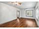 Bright living room with hardwood floors, a ceiling fan and freshly painted walls at 211 Indiana Ave, St Cloud, FL 34769