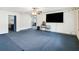 Expansive living room area with a large television, modern decor, and comfortable carpet at 211 Indiana Ave, St Cloud, FL 34769