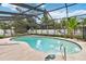 Private screened-in pool area featuring a beautifully shaped pool and ample space for lounging at 211 Indiana Ave, St Cloud, FL 34769