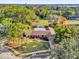 Single-story home with a pool, nestled among tall trees at 223 Royal Oaks Cir, Longwood, FL 32779