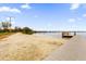 Community beach with swimming area and convenient dock, perfect for relaxing lakefront enjoyment at 223 Royal Oaks Cir, Longwood, FL 32779