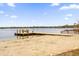 Enjoy waterfront living with sandy beach access and a private wooden dock on a serene lake at 223 Royal Oaks Cir, Longwood, FL 32779
