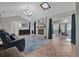 Bright living room features a fireplace, tile floors, and a view into the adjacent sunroom at 223 Royal Oaks Cir, Longwood, FL 32779