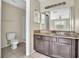 Bathroom features granite countertop and dark brown vanity at 2321 Prime Cir # B, Kissimmee, FL 34746