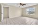 Bright bedroom featuring a ceiling fan and window with a view at 2321 Prime Cir # B, Kissimmee, FL 34746