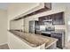 Kitchen boasts granite countertops and dark wood cabinets at 2321 Prime Cir # B, Kissimmee, FL 34746