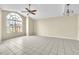Living room with large arched window and tile floors at 2321 Prime Cir # B, Kissimmee, FL 34746
