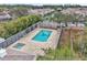 Community pool and spa with surrounding patio at 2321 Prime Cir # B, Kissimmee, FL 34746