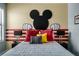 Mickey Mouse themed bedroom with a red and black accent wall at 2641 Tranquility Way, Kissimmee, FL 34746