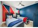 Twin bedroom with blue and red accents at 2641 Tranquility Way, Kissimmee, FL 34746