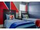 Twin bedroom with blue and red accents at 2641 Tranquility Way, Kissimmee, FL 34746