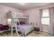 A bedroom with a bunk bed, a desk, and a purple chair at 2641 Tranquility Way, Kissimmee, FL 34746