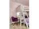 A white bunk bed with a built-in desk and purple bedding at 2641 Tranquility Way, Kissimmee, FL 34746