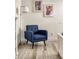 Blue accent chair in front of a wall with framed art at 2641 Tranquility Way, Kissimmee, FL 34746