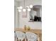 Elegant dining area with a long wooden table and modern light fixture at 2641 Tranquility Way, Kissimmee, FL 34746