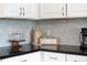 Kitchen detail showcasing modern backsplash and dark countertops at 2641 Tranquility Way, Kissimmee, FL 34746