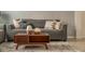 Living room with gray couch and wood coffee table at 2641 Tranquility Way, Kissimmee, FL 34746