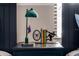 A bedroom nightstand with a green lamp, Spider-Personal bookends, and figurines at 2641 Tranquility Way, Kissimmee, FL 34746
