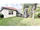 House backyard with screened lanai and lush lawn at 273 Ancona Ave, Debary, FL 32713