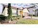 Landscaped yard with a one-story house and brown garage door at 273 Ancona Ave, Debary, FL 32713