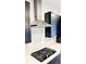 Modern kitchen with black cabinets, quartz countertops, and stainless steel appliances at 273 Ancona Ave, Debary, FL 32713