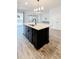 Kitchen island with black cabinets and quartz countertop at 273 Ancona Ave, Debary, FL 32713