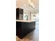 Kitchen island with black cabinets and quartz countertop at 273 Ancona Ave, Debary, FL 32713