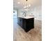 Modern kitchen island with a farmhouse sink and pendant lighting at 273 Ancona Ave, Debary, FL 32713