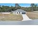 Modern house with a gray roof and driveway at 2831 Sw 166Th Ln, Ocala, FL 34473