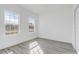 Bright bedroom with wood-look floors and two windows at 2831 Sw 166Th Ln, Ocala, FL 34473