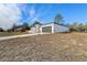 White house with a gray garage door and grassy yard at 2831 Sw 166Th Ln, Ocala, FL 34473
