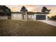 New construction home with gray garage door and landscaping at 2831 Sw 166Th Ln, Ocala, FL 34473