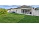Large backyard with a grassy lawn and screened enclosure at 305 Therese St, Davenport, FL 33897