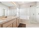 Primary bathroom with a double vanity and a soaking tub at 305 Therese St, Davenport, FL 33897