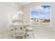 Breakfast nook with a round table and four white chairs, overlooking the street at 305 Therese St, Davenport, FL 33897